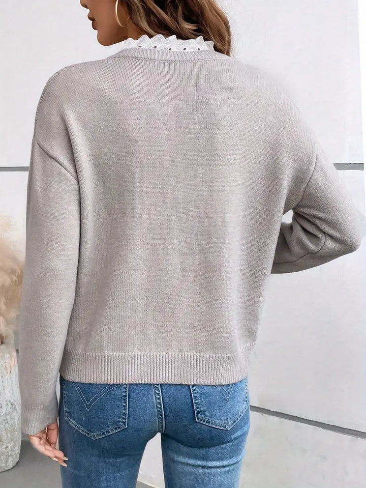 Full-body shot of a comfortable women's lace-trim V-neck pullover sweater, ideal for everyday elegance.