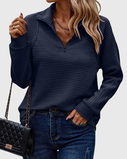 Chic women's sweater with V-neck and zipper detail. Elegant and comfortable long sleeve fashion.