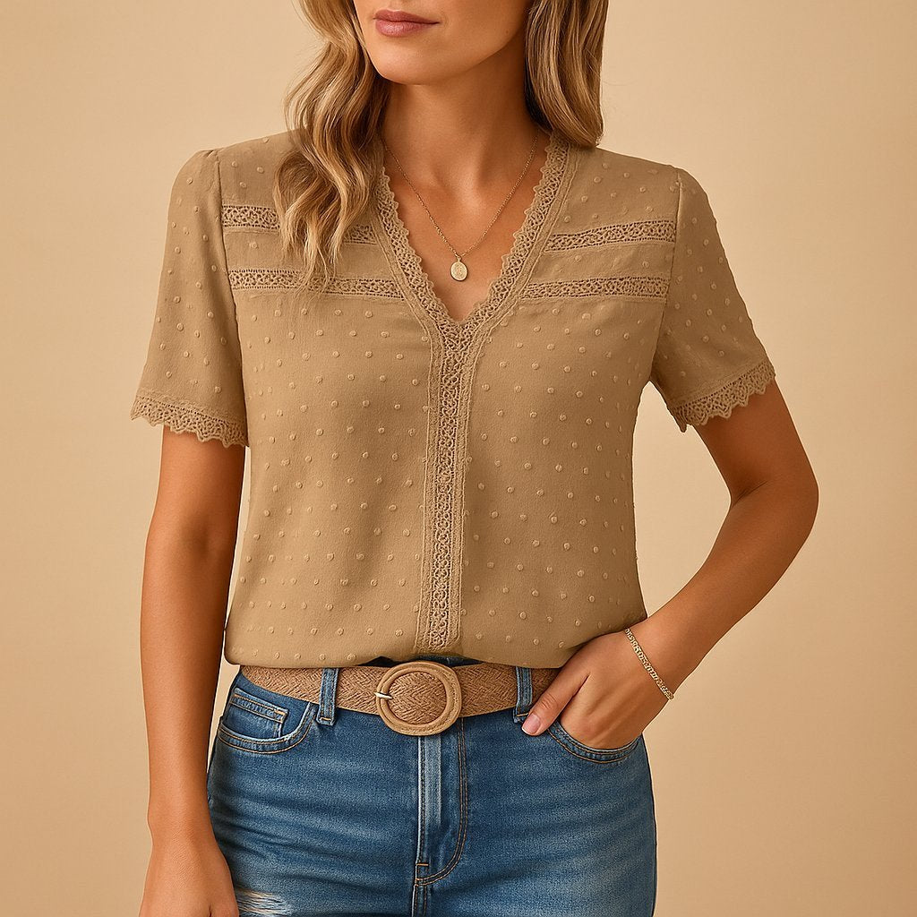 Elegant women's V-neck top with delicate lace trim and subtle textured dot fabric, perfect for spring/summer style.