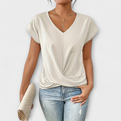 Versatile long sleeve V-neck top for women, featuring elegant button detail. A comfortable fashion piece.