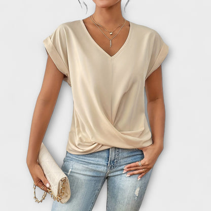 Stylish V-neck blouse for women with elegant button detail. Comfortable and perfect for everyday wear.