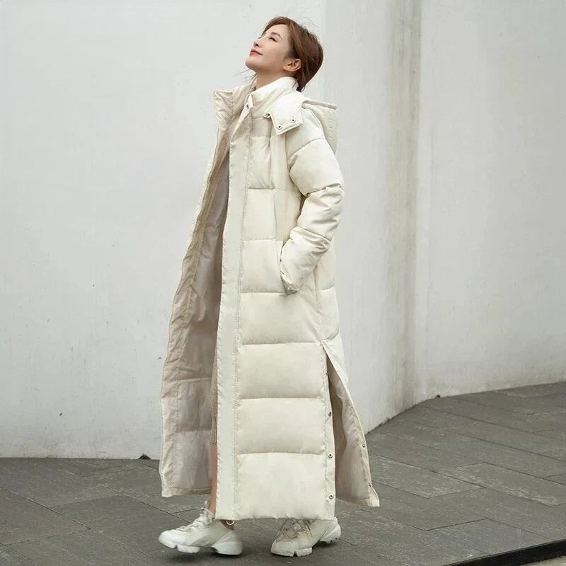 Women's elegant quilted winter coat with hood, offering warmth & windproof protection for cold days.