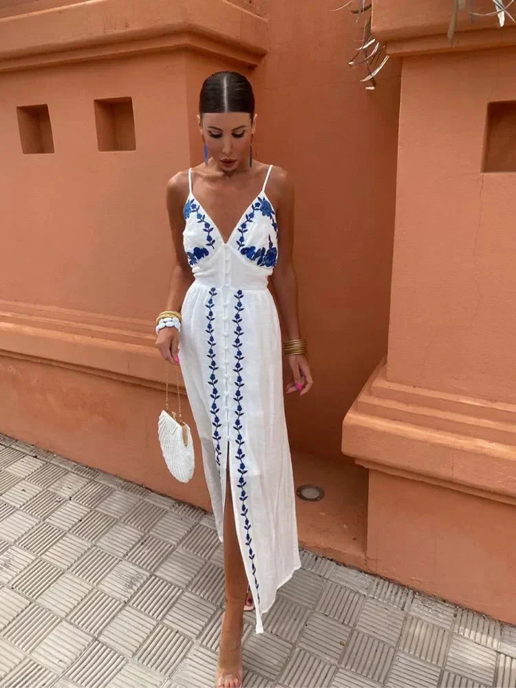 Elegant women's white boho embroidered maxi dress with floral details, perfect for a wedding guest or summer vacation.