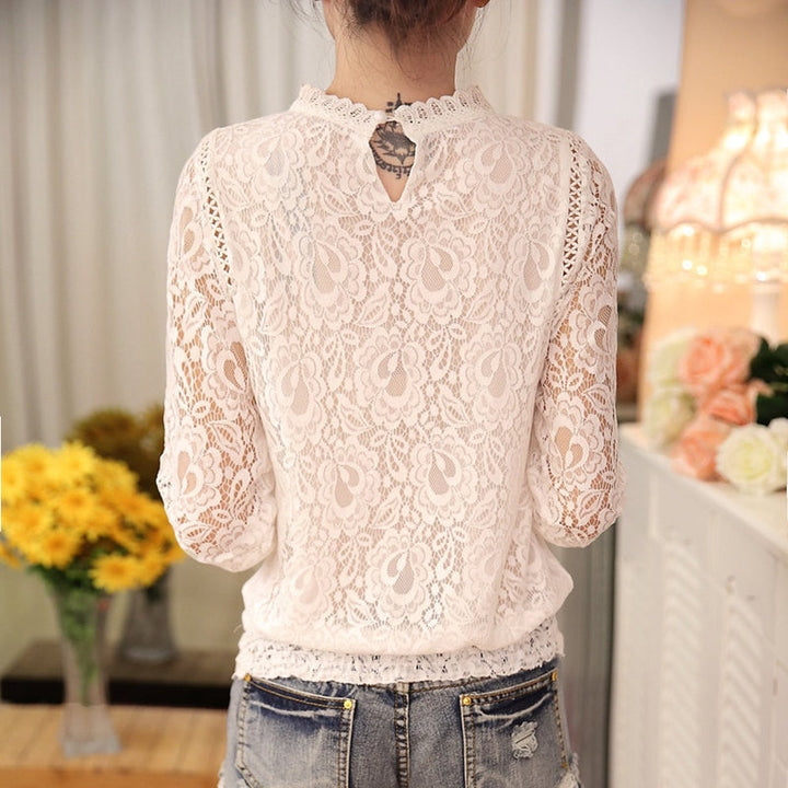 Detailed women's lace blouse featuring intricate long sleeves. An elegant & chic top for sophisticated womenswear.