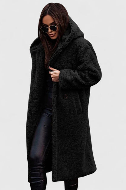 Woman wearing a stylish & warm elegant winter jacket, perfect for sophisticated outerwear.