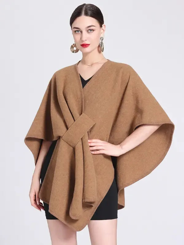 Sophisticated women's tie-front wrap top with cape sleeves, ideal for modern, smart casual, or office fashion.