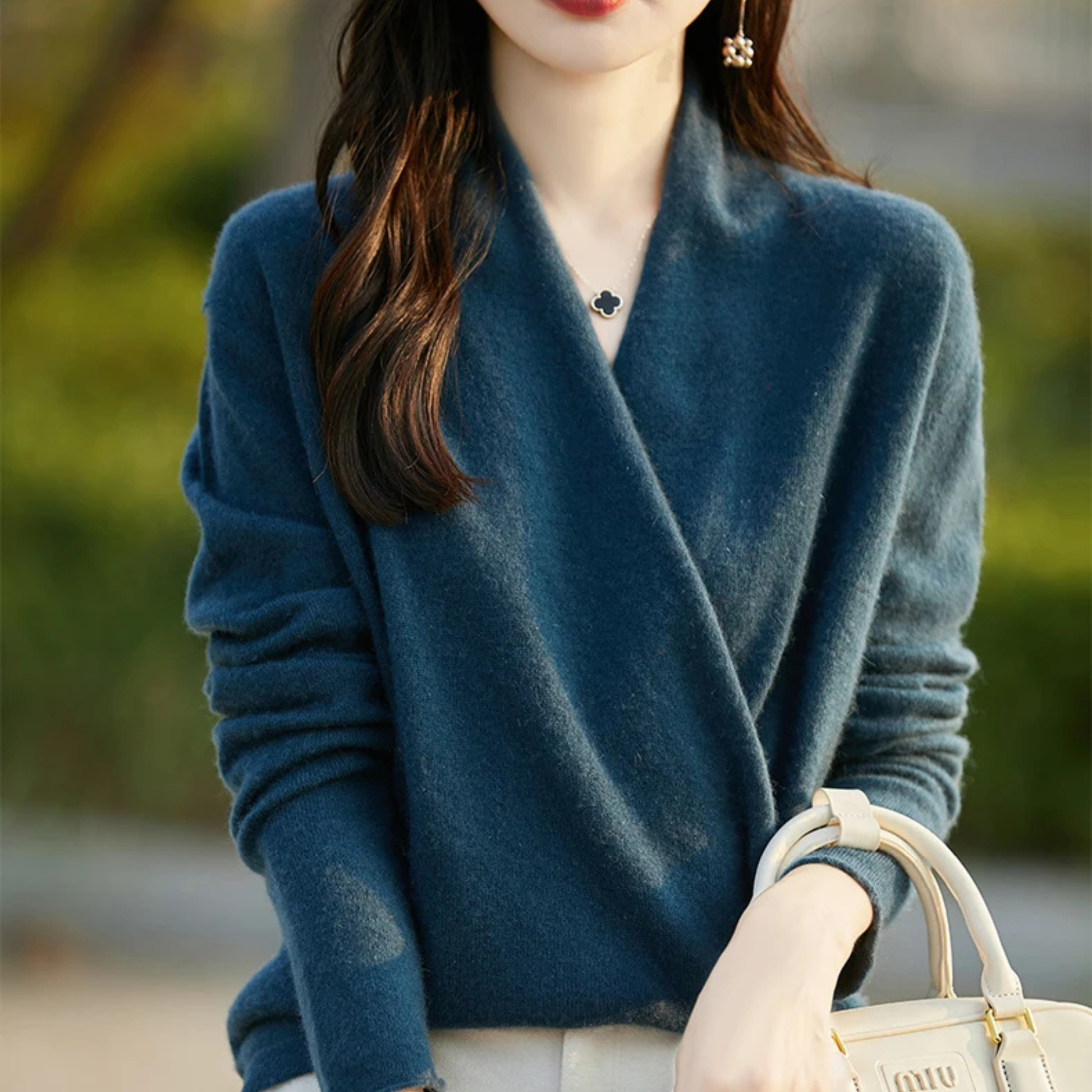 Chic women's wrap top, a modern V-neck sweater for elegant versatile wear.
