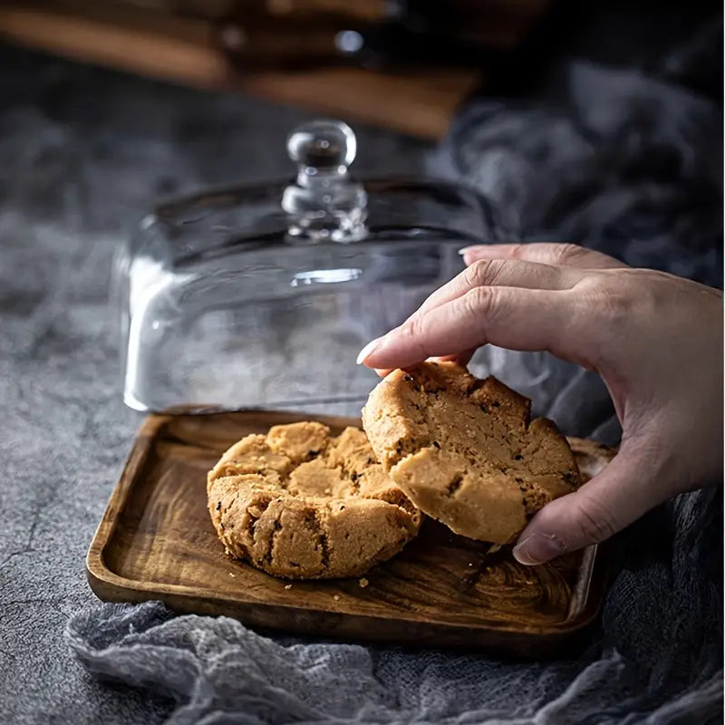 Smooth acacia wood butter dish with crystal clear glass cover, a beautiful kitchen & dining accent.
