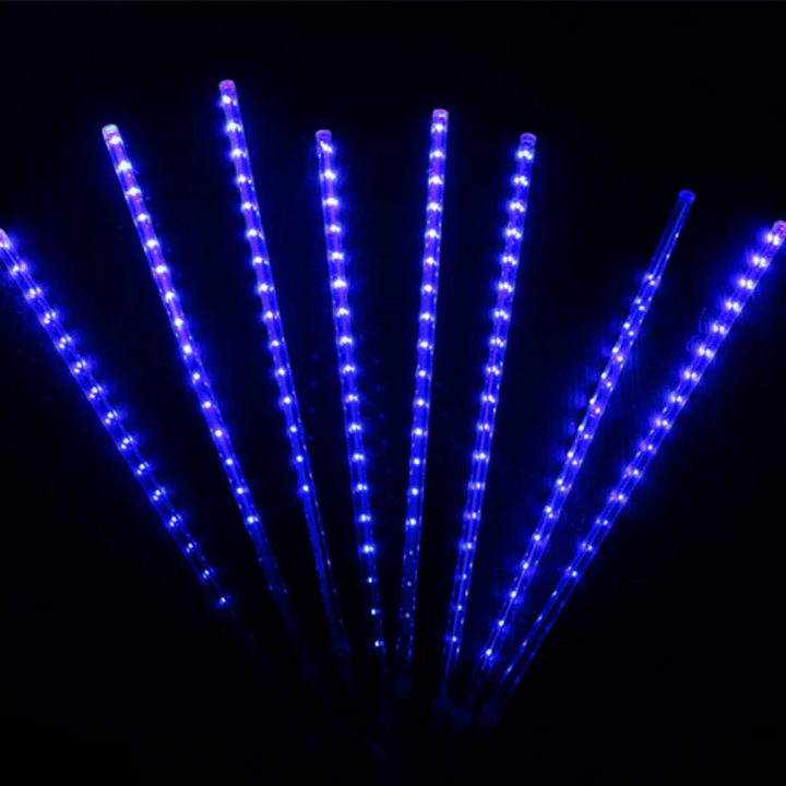 Waterproof LED snowfall projection light for outdoor winter decor, illuminating homes with festive glow.