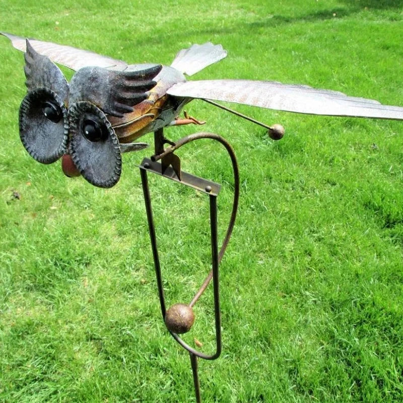 Charming owl bird wind spinner, kinetic metal outdoor decor, perfect yard art for wildlife lovers.