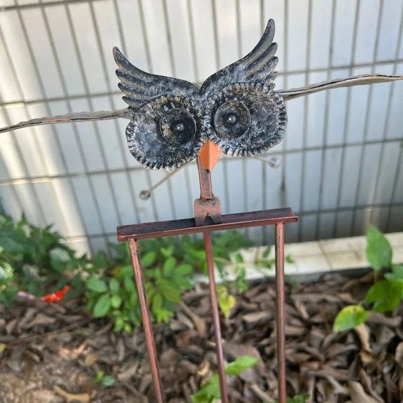 Kinetic metal bird wind spinner, vibrant outdoor garden art for dynamic patio and yard decoration.