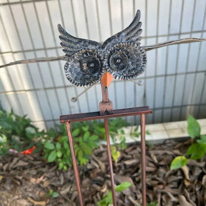 Kinetic metal bird wind spinner, vibrant outdoor garden art for dynamic patio and yard decoration.