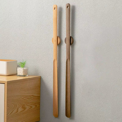 Magnetic beech wood shoehorn, an ergonomic footwear accessory for convenient entryway organization.