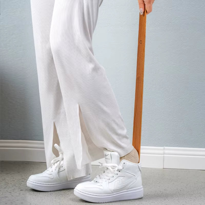 Sleek ergonomic magnetic shoehorn made from natural wood, perfect for easy shoe access & home use.