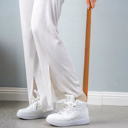 Sleek ergonomic magnetic shoehorn made from natural wood, perfect for easy shoe access & home use.