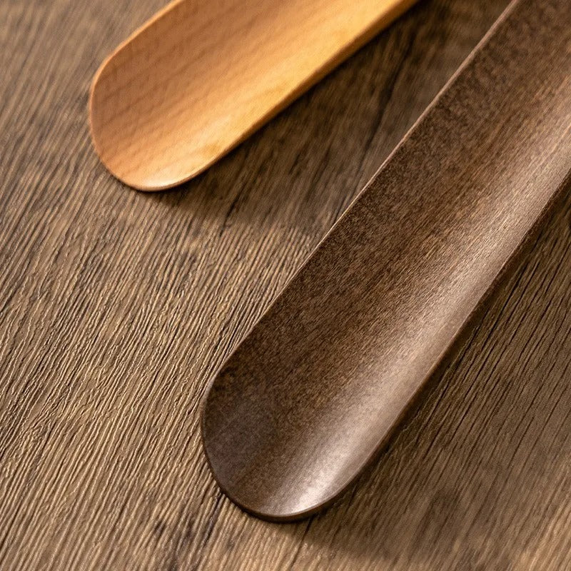 Long ergonomic magnetic shoehorn, a durable wood footwear aid for easy putting on shoes.