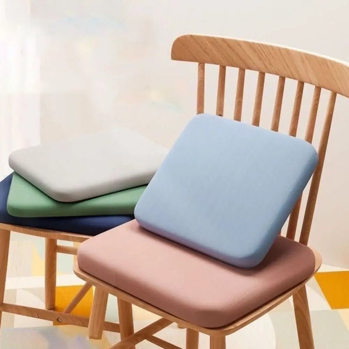 Contoured ergonomic seat cushion with non-slip base, designed for optimal posture & sitting comfort.