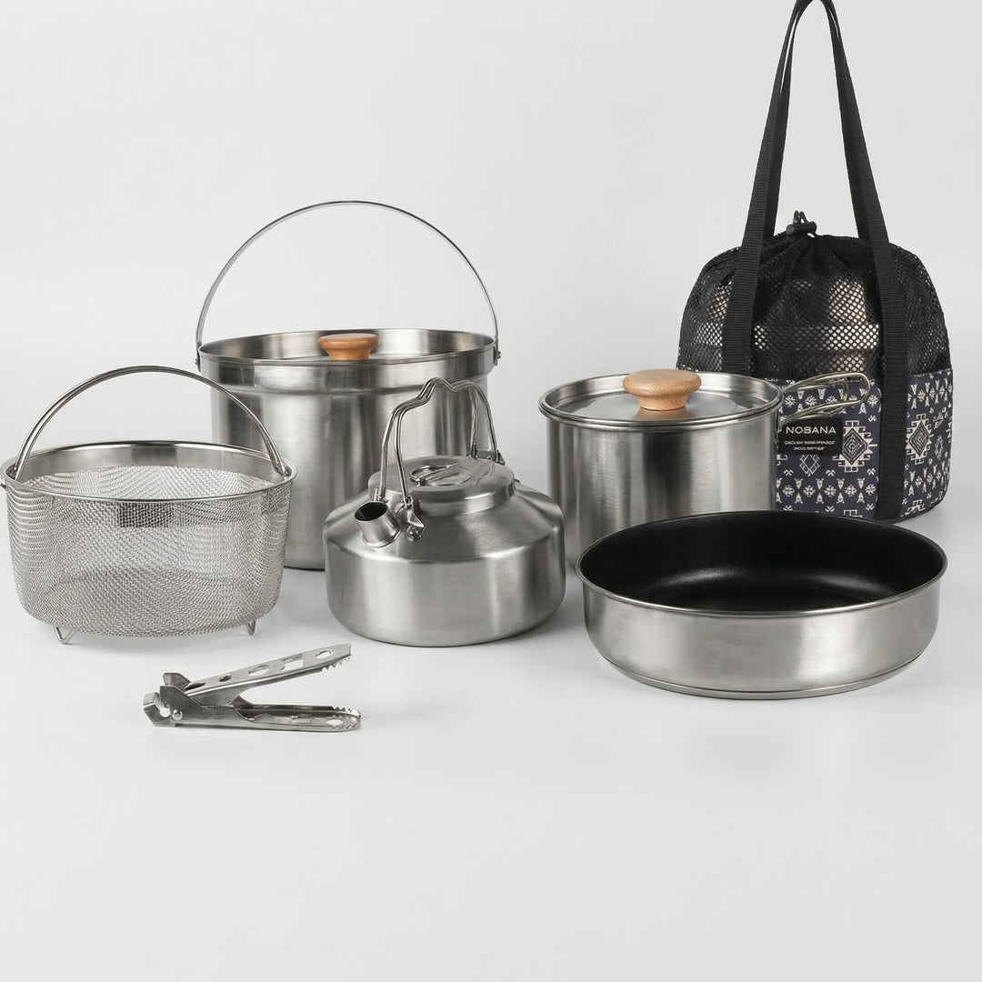 Compact camping pot and pan set, stainless steel for family outdoor cooking and picnic gear.