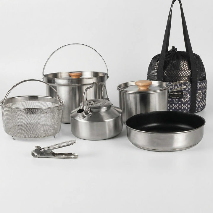 Compact camping pot and pan set, stainless steel for family outdoor cooking and picnic gear.