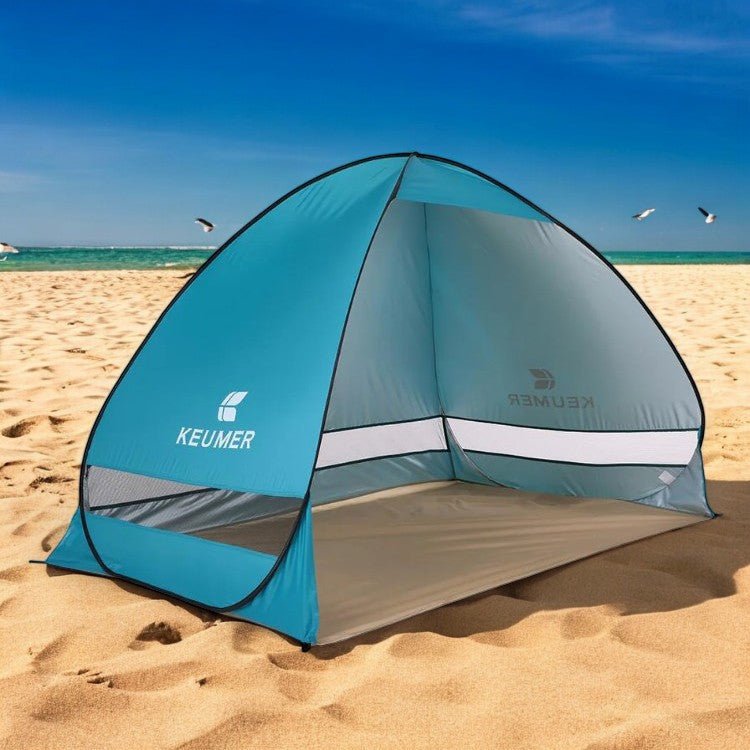Family pop-up beach tent, blue, with UV protection & wind resistance, set up on sandy beach