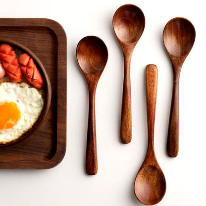 Set of natural wood cooking spoons for kitchen essentials. Includes serving & stirring tools with farmhouse style.