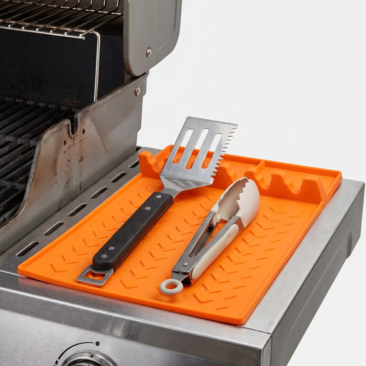Easy-clean silicone utensil rest & drip tray, perfect for organized outdoor grilling and kitchen tool storage.