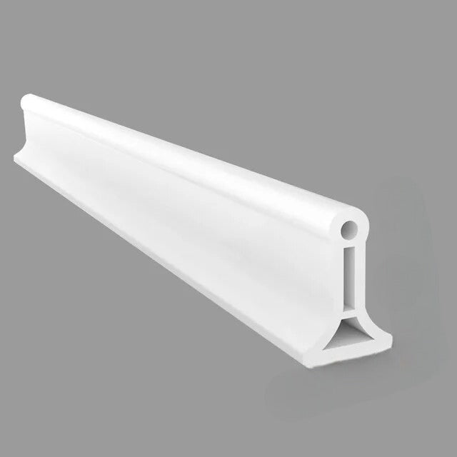 Flexible silicone shower water barrier for a dry bathroom floor. Prevents water leaks.