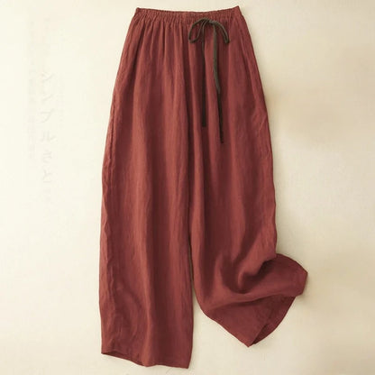 Black flowy wide-leg women's pants with an elastic waist, ideal for relaxed summer resort wear.