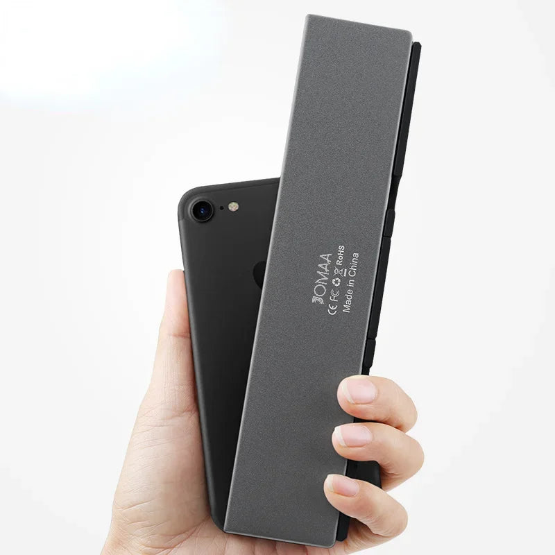 Compact foldable wireless keyboard, a perfect travel accessory for mobile productivity with universal compatibility.