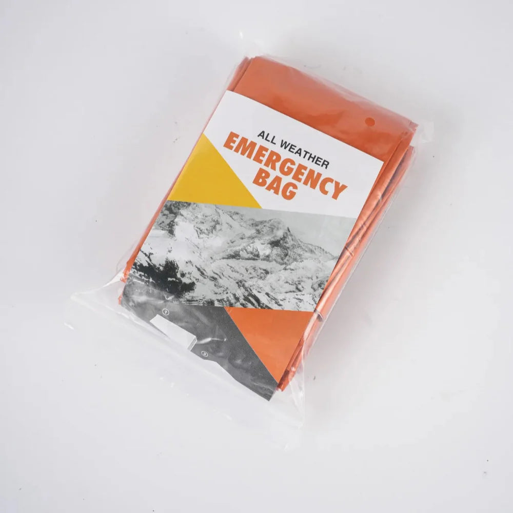 Four survival sleeping bags, rolled up, depicting their small size ideal for first aid kits and outdoor safety.
