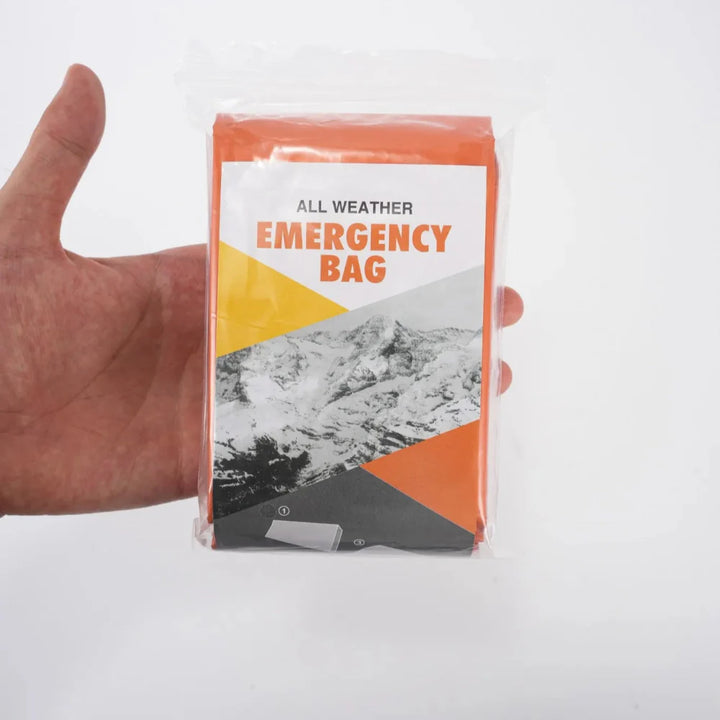 Emergency mylar sleeping bags, 4-pack, shown against an outdoor backdrop, perfect for camping & survival gear.