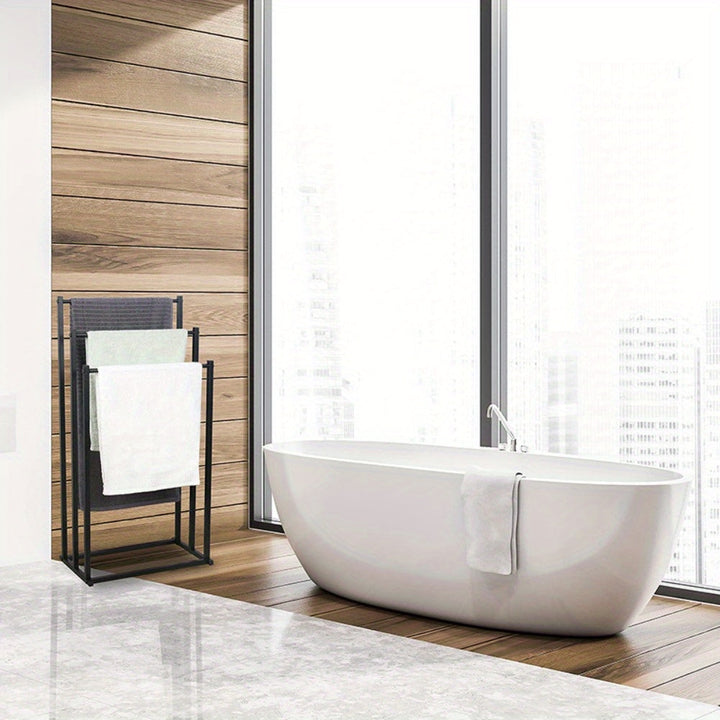 Compact freestanding steel towel rack, perfect for small bathrooms and versatile towel storage solution.