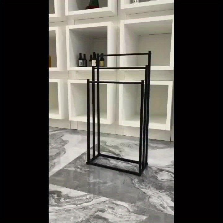 NeatRack freestanding steel towel rack, modern bathroom storage solution for organized towels.
