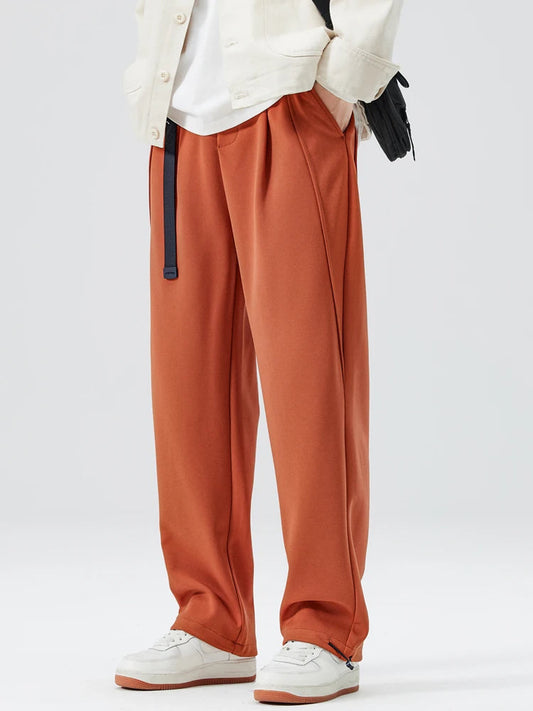 Front view of men's stylish wide-leg trousers, relaxed fit with drawstring waist for modern comfort.