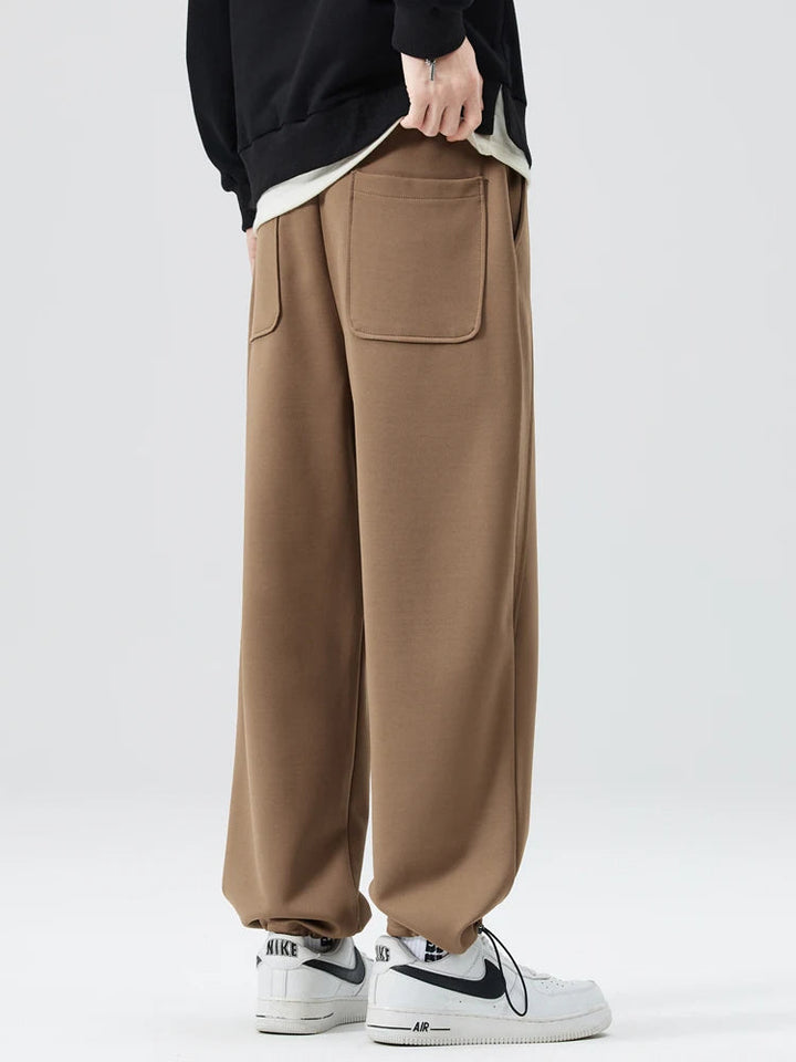 Hung men's wide-leg trousers, showcasing the full silhouette and modern, stylish design.