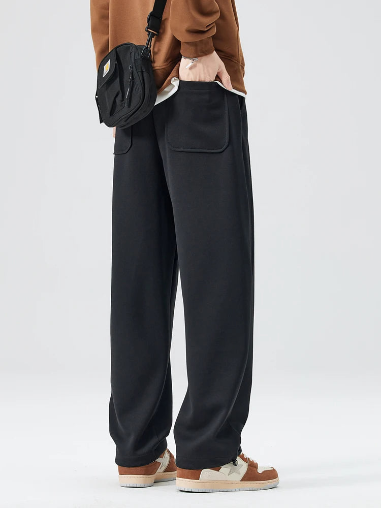 Model in men's wide-leg trousers paired with a smart casual shirt, showcasing modern style.