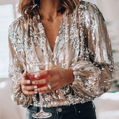 Full shot of a women's sparkling sequin blouse, perfect for evening wear & party outfits. Long sleeve, glam fashion top.