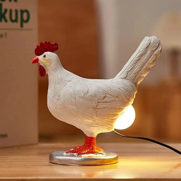 Unique chicken table lamp offering ambient lighting for home decor. A funny LED novelty gift.