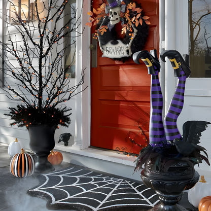 Halloween witch leg yard stakes set. Whimsical outdoor decor for a festive and spooky garden display.