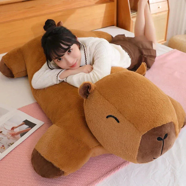Side profile of a fluffy giant capybara plush, a soft comfort gift & snuggle buddy.