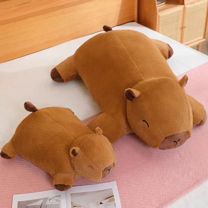 Snuggling with a giant capybara plush, the ultimate soft comfort gift for animal lovers.