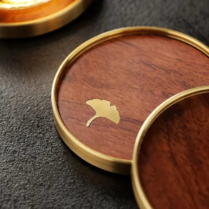 Set of 4 artisan wooden coasters with beautiful ginkgo leaf engravings, perfect for luxury home decor & gifts.