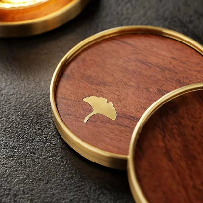 Set of 4 artisan wooden coasters with beautiful ginkgo leaf engravings, perfect for luxury home decor & gifts.