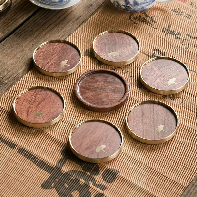 Elegant wooden ginkgo coasters, designed to protect surfaces from drinks while adding luxury artisan style.
