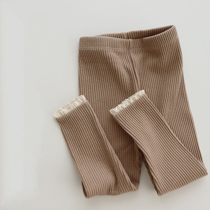 Comfortable ribbed knit baby leggings for girls, featuring a delicate lace trim detail. Ideal for everyday.
