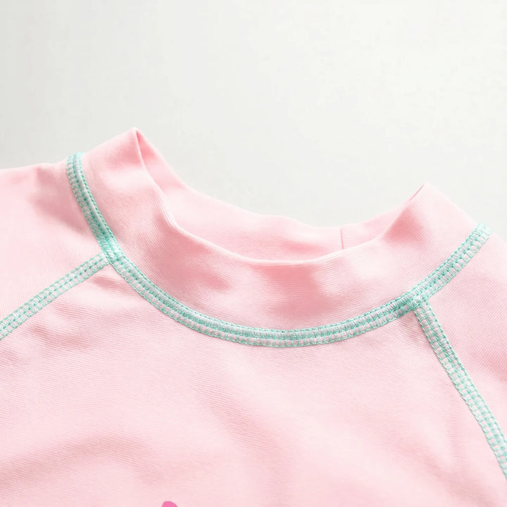 Kids' UPF 50+ long-sleeve rash guard swimwear set, quick-dry fabric for sun-safe beach and pool fun.