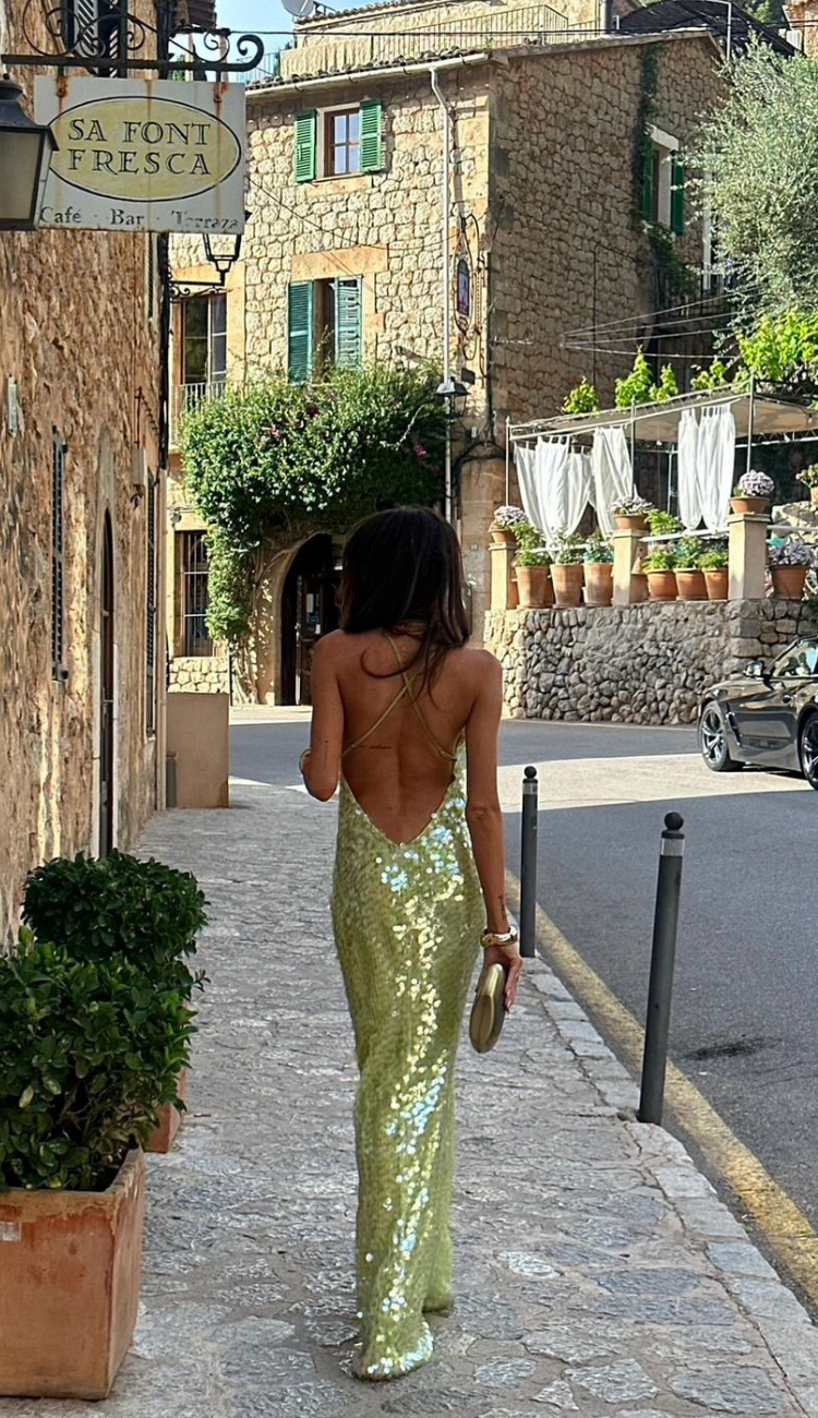 Stunning women's green spaghetti strap maxi dress with a chic backless design for glamorous formal events.