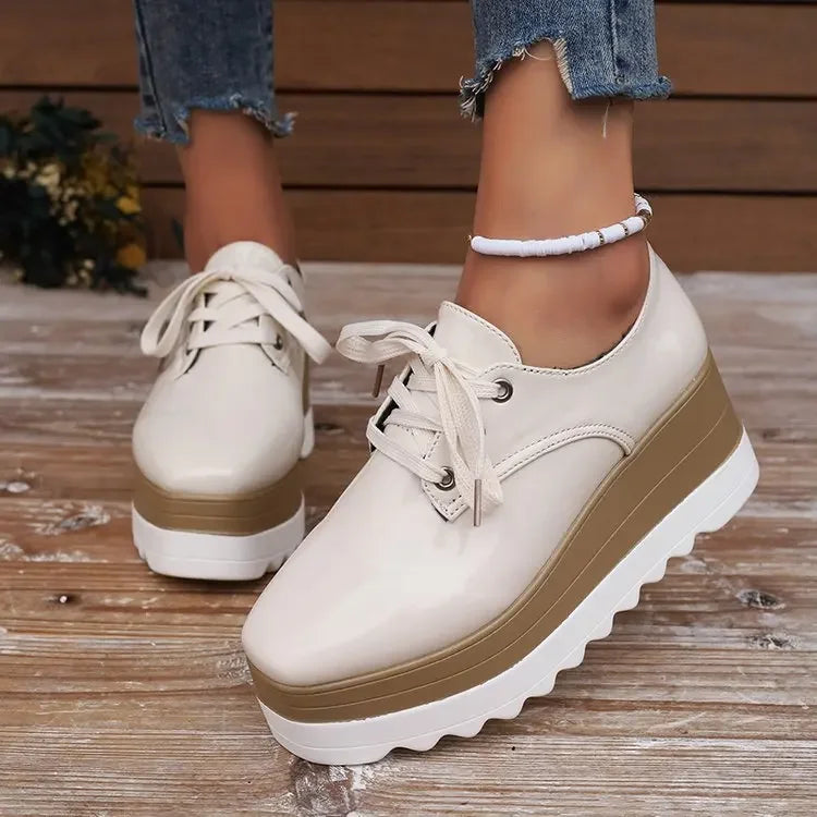 Trendy women's glossy chunky sneakers with a platform heel, perfect for everyday comfortable fashion.