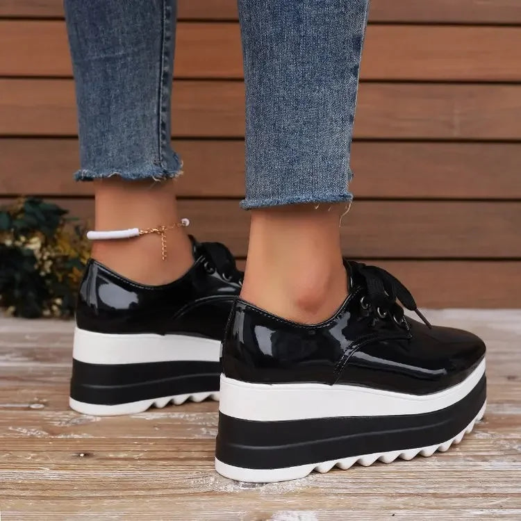 Black glossy platform sneakers for women, offering orthopedic comfort and a chic chunky casual look.