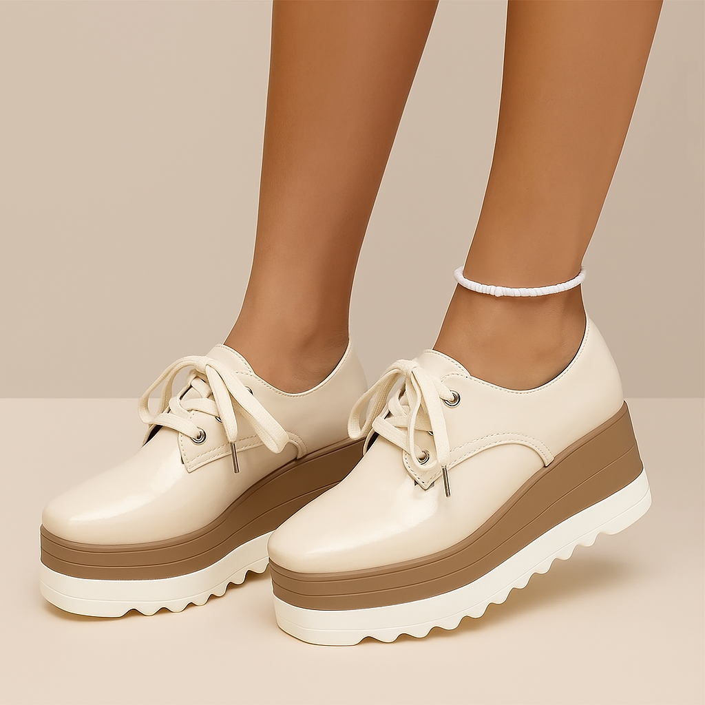 High-shine glossy platform sneakers for women, offering comfortable support and a trendy chunky style.
